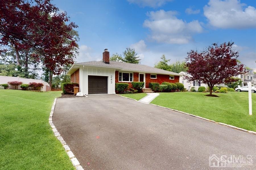 243 Old Tote Road Mountainside, NJ 07092 - Photo 1 of 42 a front view of a house with a yard