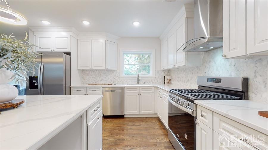 243 Old Tote Road Mountainside, NJ 07092 - Photo 11 of 42 a kitchen with stainless steel appliances kitchen island granite countertop a sink and cabinets