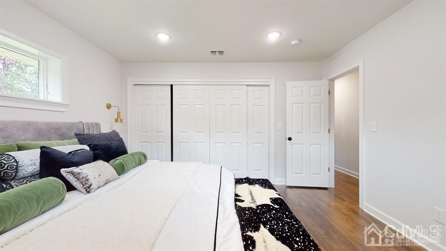 243 Old Tote Road Mountainside, NJ 07092 - Photo 19 of 42 a bedroom with a bed and wooden floor