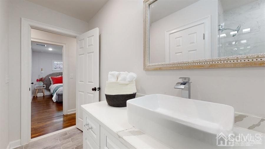 243 Old Tote Road Mountainside, NJ 07092 - Photo 23 of 42 a en suite bathroom with a granite countertop tub and a mirror
