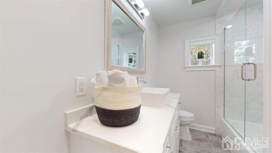 243 Old Tote Road Mountainside, NJ 07092 - Photo 24 of 42 a bathroom with a toilet and a mirror