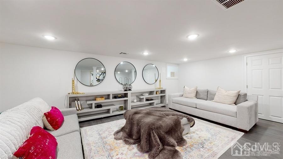 243 Old Tote Road Mountainside, NJ 07092 - Photo 31 of 42 a living room with furniture a mirror and white walls