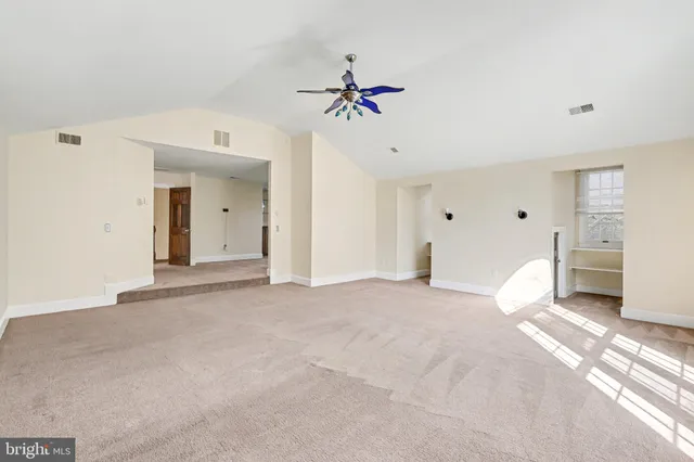a view of a livingroom with a ceiling fan and window