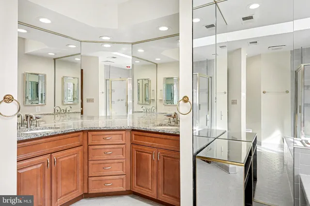a bathroom with a granite countertop sink mirror and double