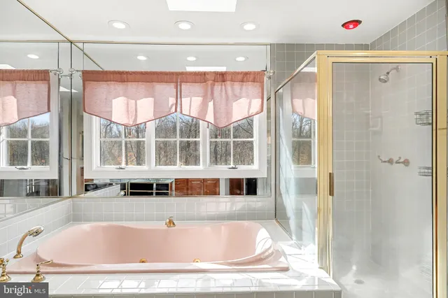 a bathroom with bathtub and windows
