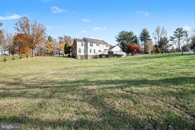 a view of a big yard with a house in the background