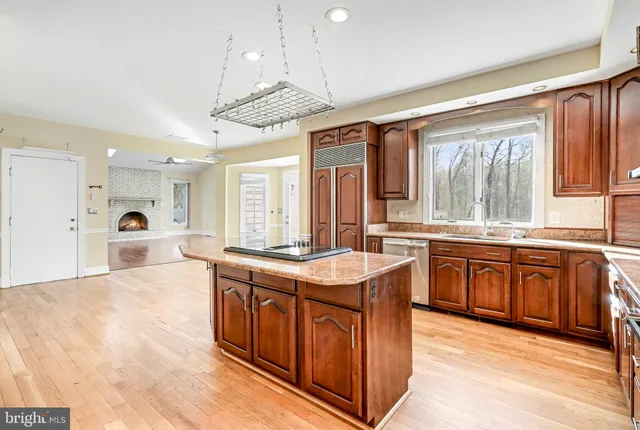 a large kitchen with kitchen island a large island in the center and stainless steel appliances