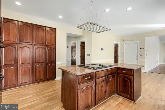a kitchen with stainless steel appliances granite countertop a sink and a refrigerator