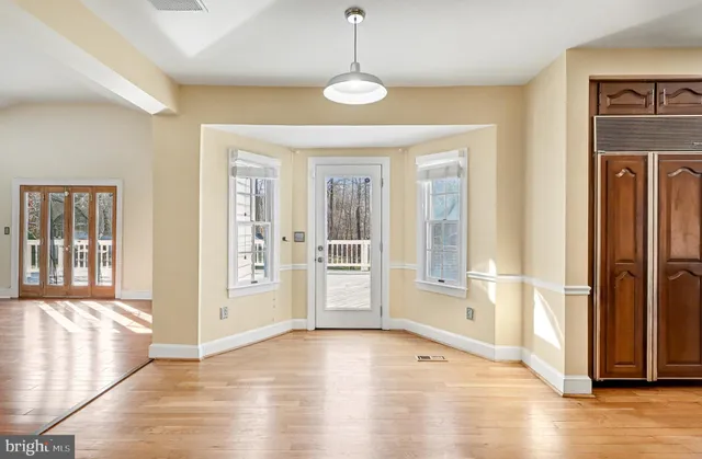 a view of an entryway with wooden floor and door