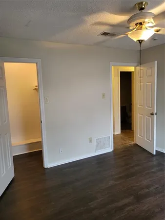 an empty room with wooden floor and door
