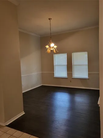 a room with hard wood floors and a window