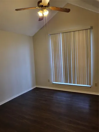 a view of wooden floor and chandelier fan in a room