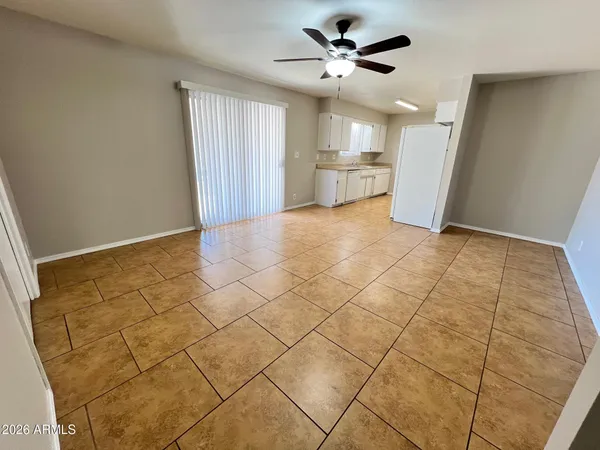 a view of a kitchen with a sink and a chandelier fan
