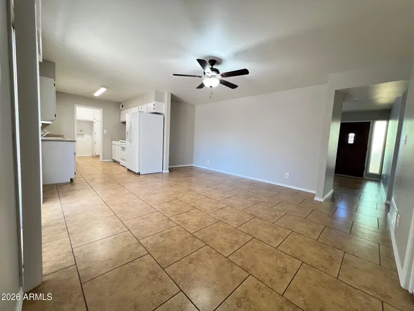 a kitchen with granite countertop a refrigerator a sink and dishwasher