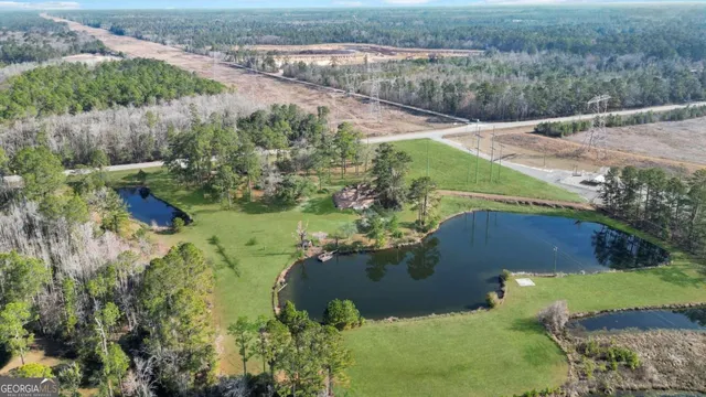 an aerial view of a house with a yard