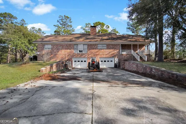 a view of a house with a yard and furniture