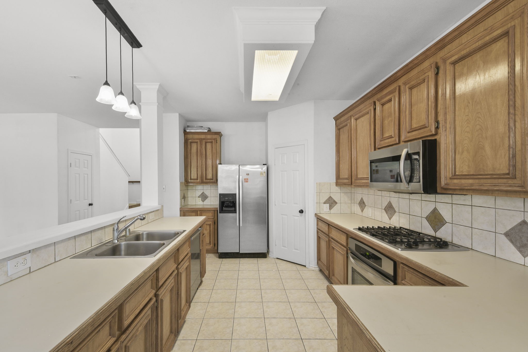 8550 Waiting Spring Circle Houston, TX 77095 - Photo 13 of 32 a kitchen with stainless steel appliances granite countertop a sink stove and refrigerator