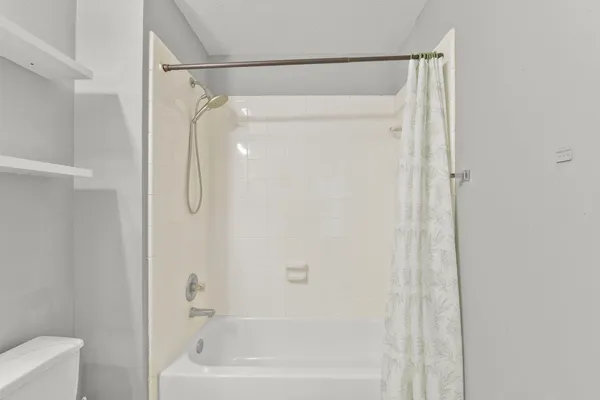 a bathroom with a shower and a bath tub