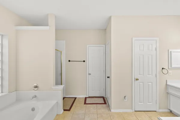 a bathroom with a bathtub and a shower