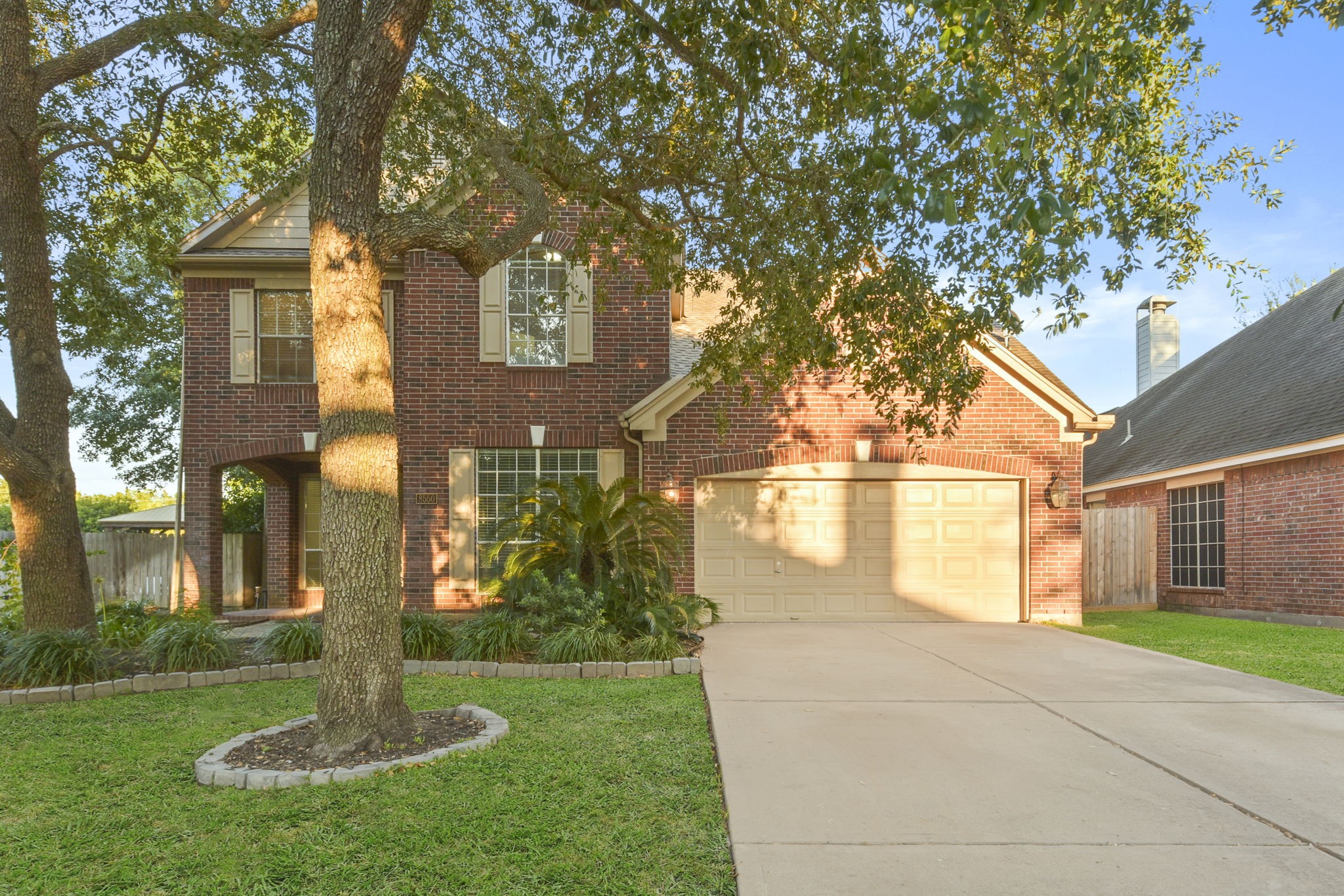 8550 Waiting Spring Circle Houston, TX 77095 - Photo 2 of 32 a front view of a house with a yard and fountain