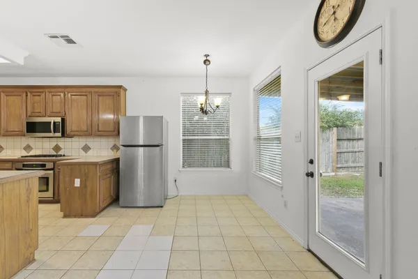 a kitchen with a refrigerator a stove top oven a sink and dishwasher