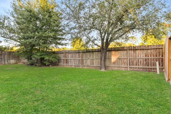 a view of a backyard with large trees
