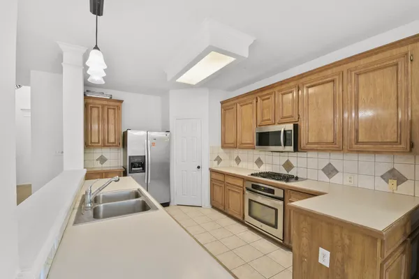 a kitchen that has a sink cabinets counter space and a window