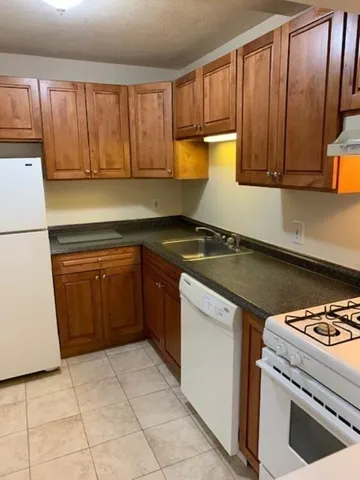 a kitchen with a stove top oven sink and cabinets