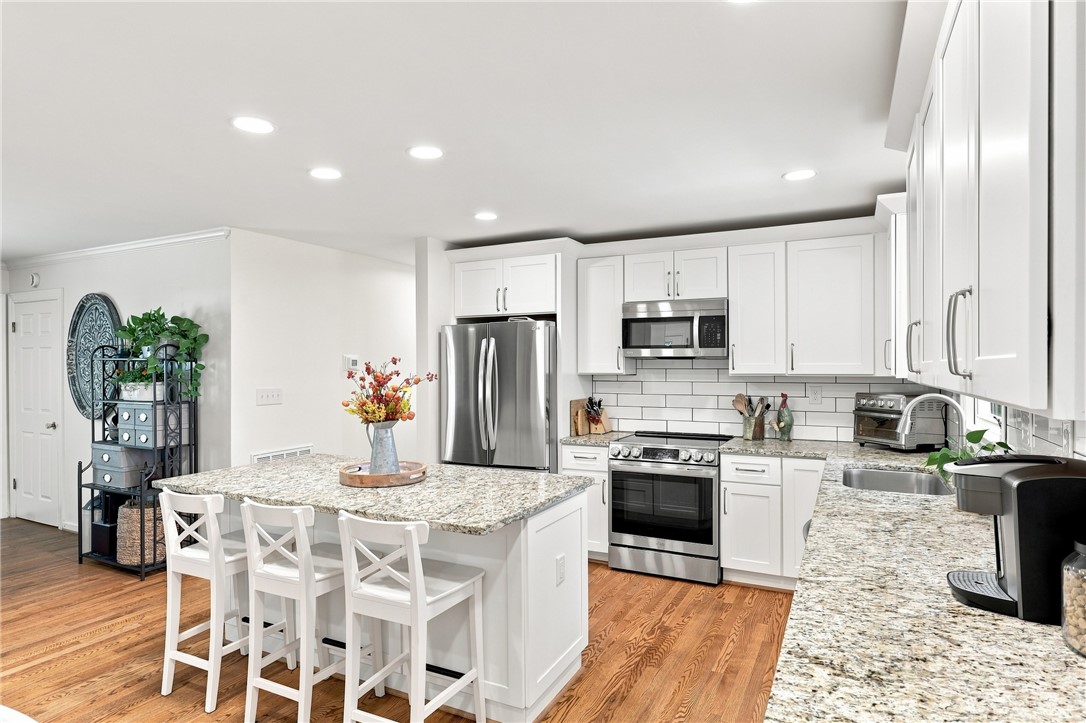204 Sylvia Road Easley, SC 29642 - Photo 11 of 36 A well-appointed kitchen boasts sleek stainless steel appliances, abundant cabinetry, and a central island.