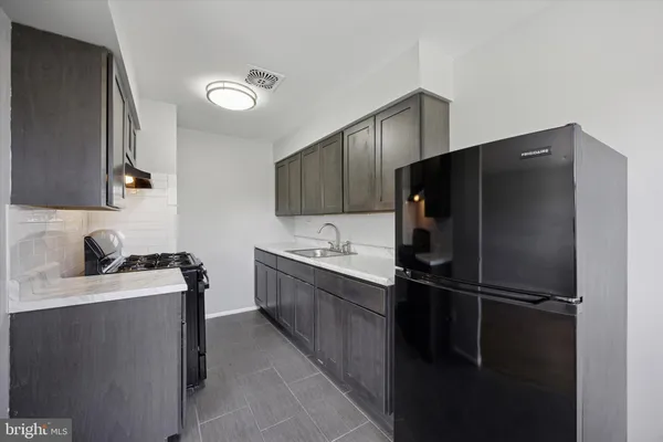 a kitchen with a refrigerator and a sink