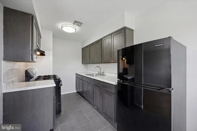 a kitchen with a refrigerator and a sink