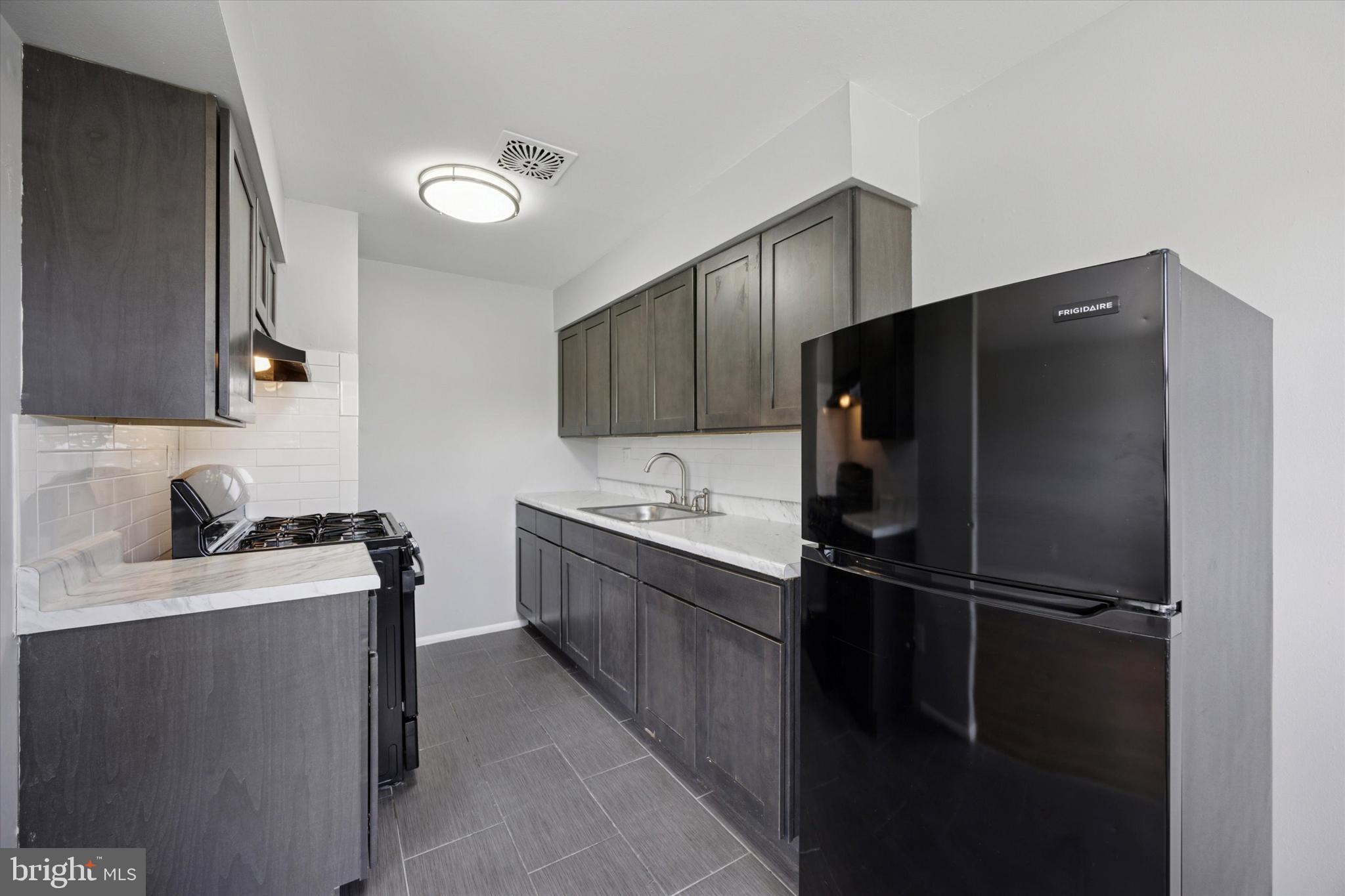 8410 Bustleton Avenue, Unit A 14 Philadelphia, PA 19152 - Photo 12 of 15 a kitchen with a refrigerator and a sink