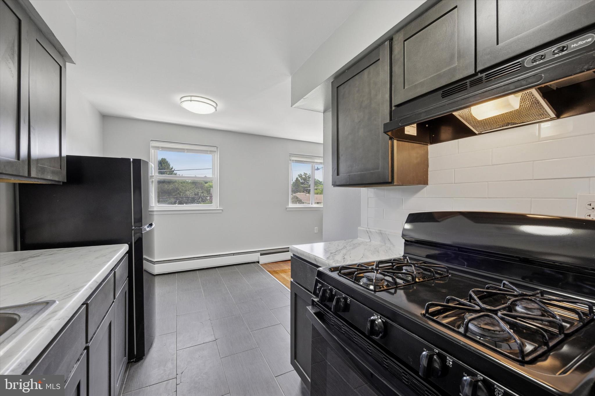 8410 Bustleton Avenue, Unit A 14 Philadelphia, PA 19152 - Photo 14 of 15 a stove top oven sitting inside of a kitchen