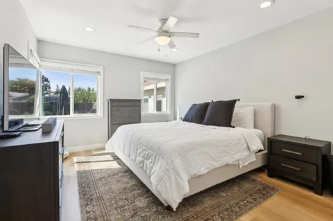 a bedroom with a large bed and a large window