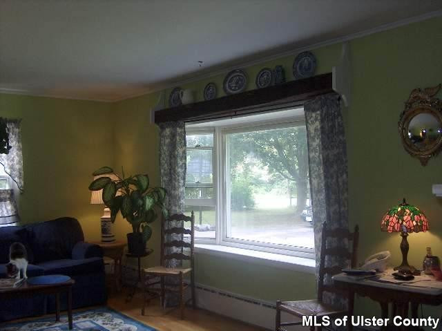 171 Pine Bush Road, Unit CONTINGENCY CONT TO SHOW Stone Ridge, NY 12484 - Photo 1 of 4 a living room with furniture and garden view