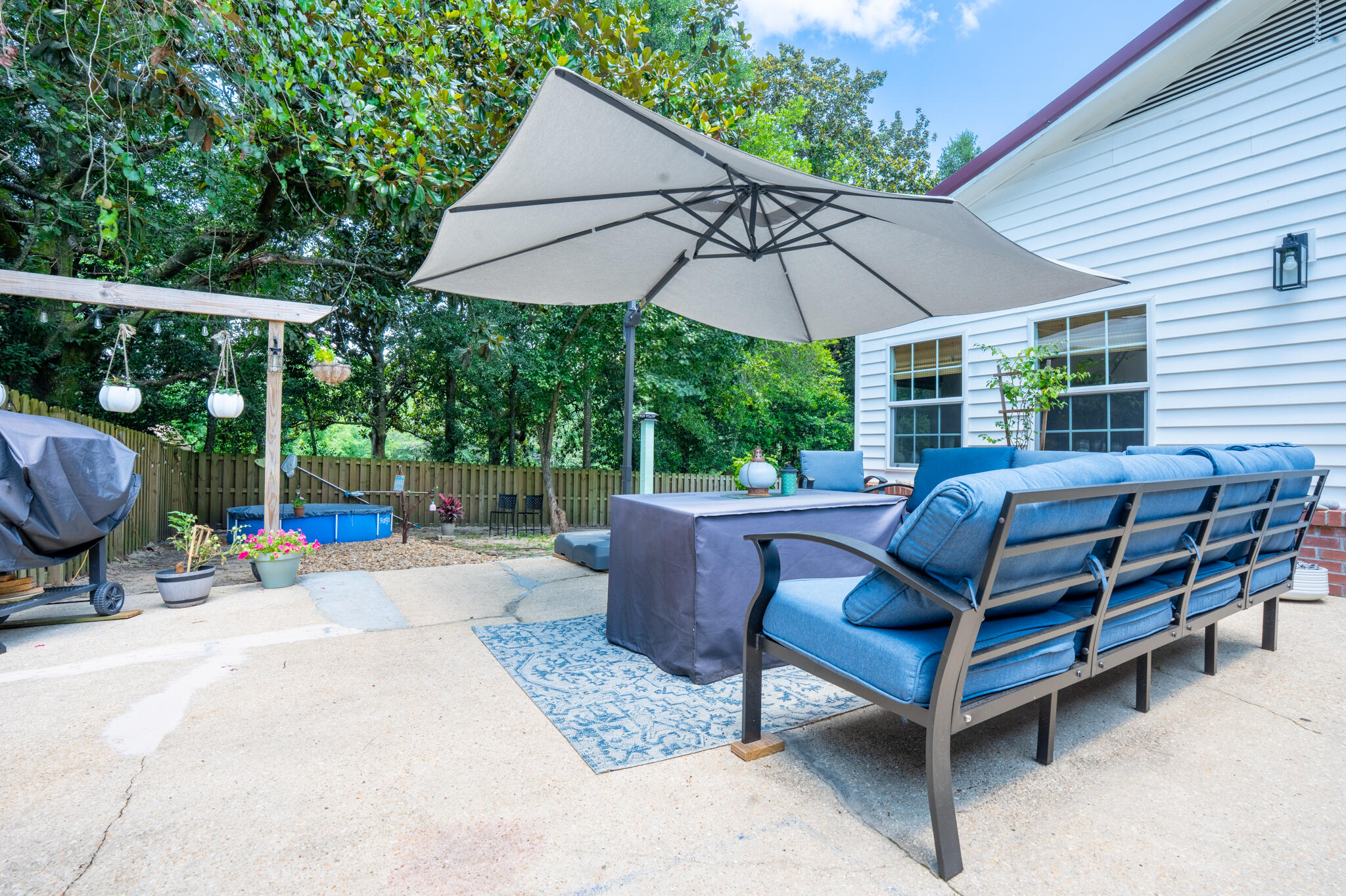 156 Lindberg Street Crestview, FL 32536 - Photo 15 of 25 a view of a patio with a table and chairs under an umbrella