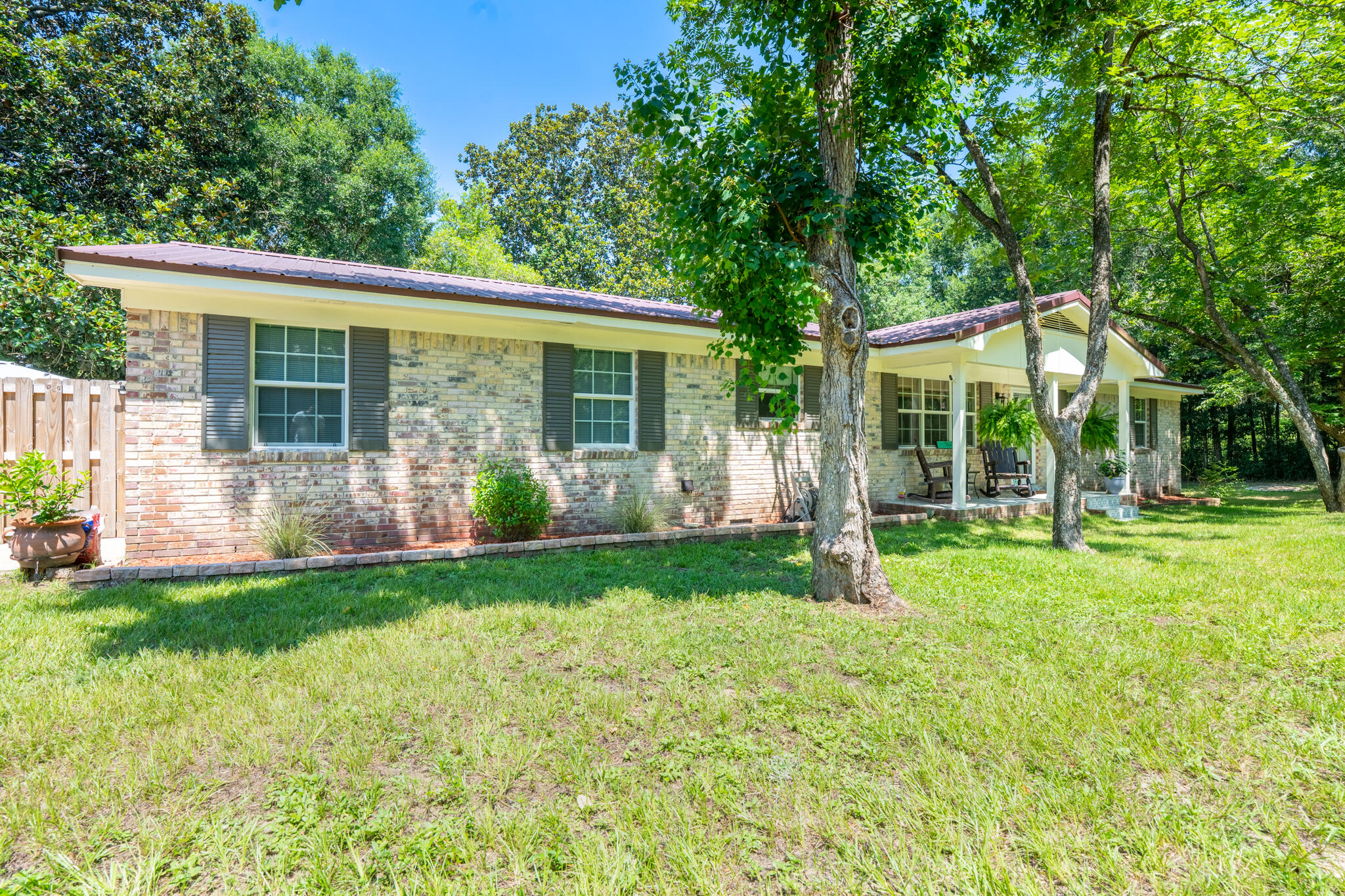 156 Lindberg Street Crestview, FL 32536 - Photo 2 of 25 a view of a house with backyard and a garden