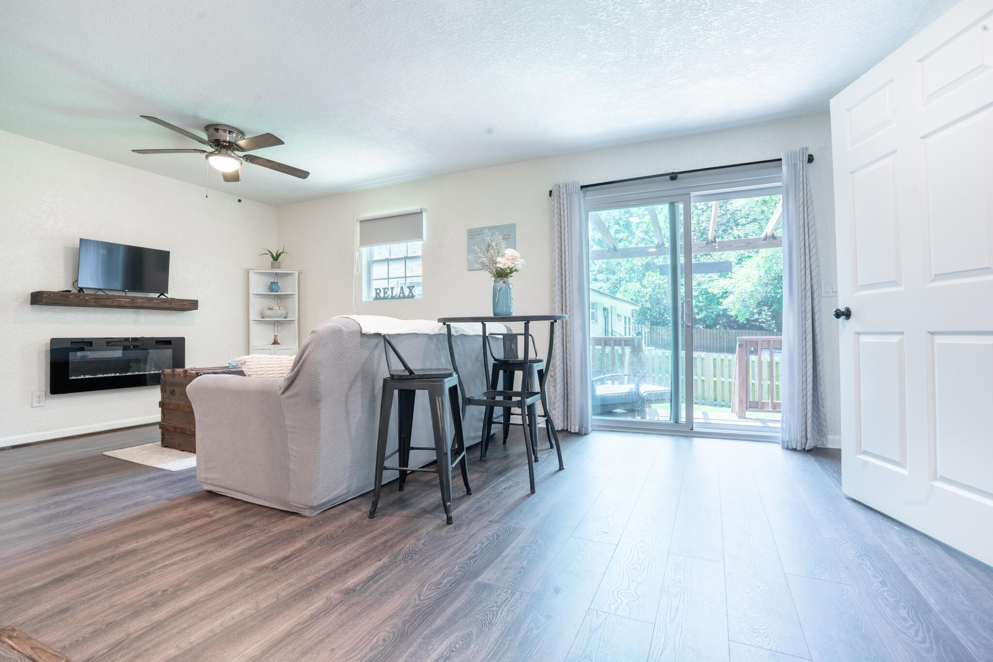 156 Lindberg Street Crestview, FL 32536 - Photo 22 of 25 a living room with furniture a fireplace and a flat screen tv