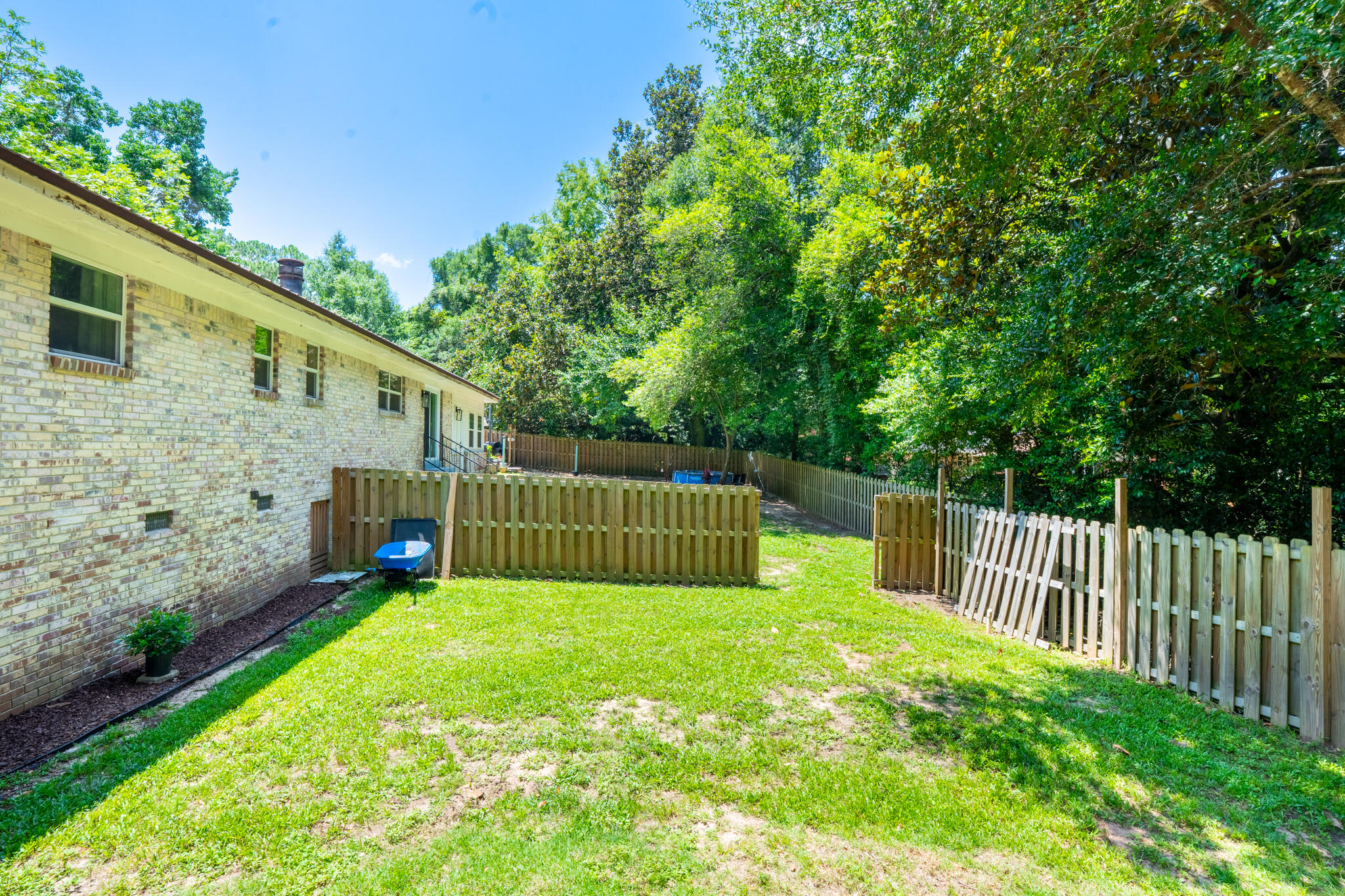 156 Lindberg Street Crestview, FL 32536 - Photo 23 of 25 a view of a backyard with a small cabin