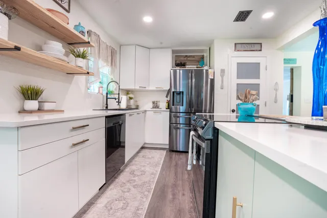 a kitchen with a sink stove and refrigerator