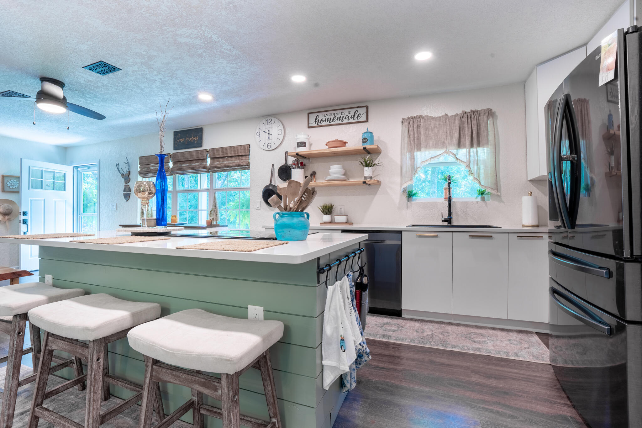 156 Lindberg Street Crestview, FL 32536 - Photo 6 of 25 a kitchen with stainless steel appliances granite countertop a sink and a refrigerator