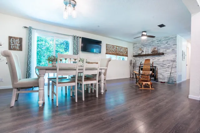a view of a dining room with furniture and wooden floor
