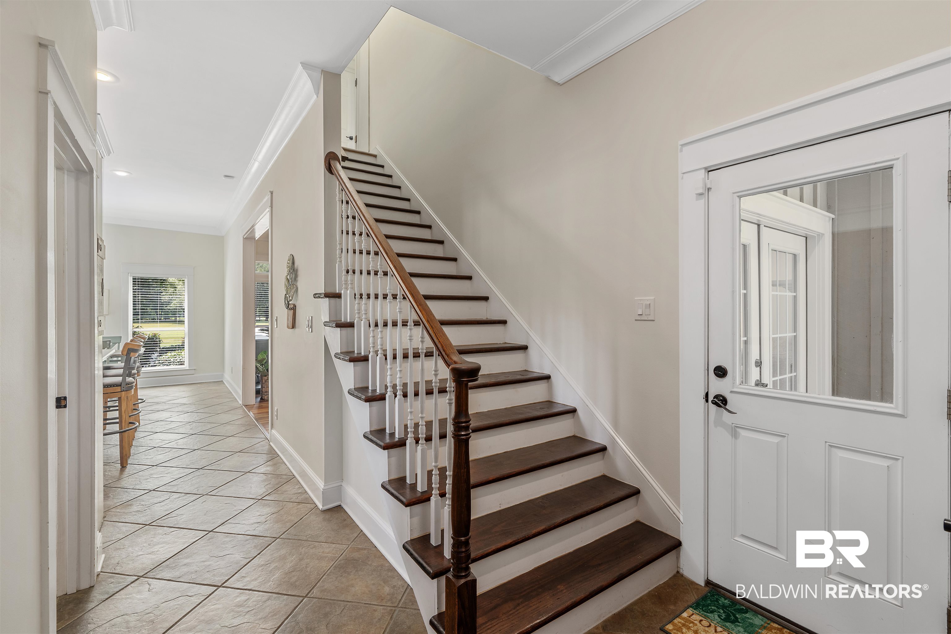 16330 Danne Road Fairhope, AL 36532 - Photo 16 of 43 Stairs featuring light tile patterned floors and crown molding