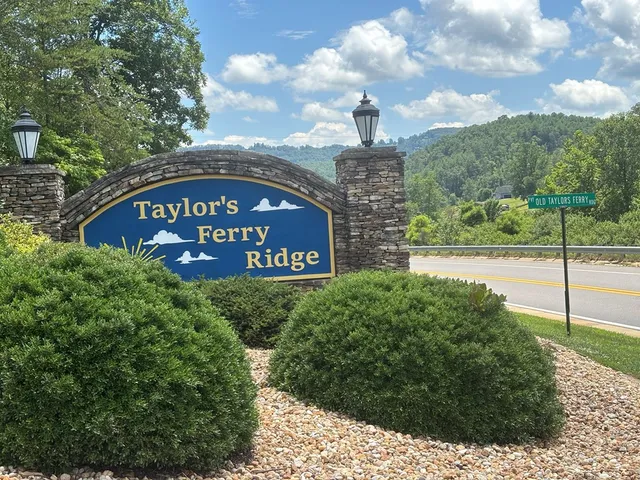 a sign of golf club on a wall under a tree