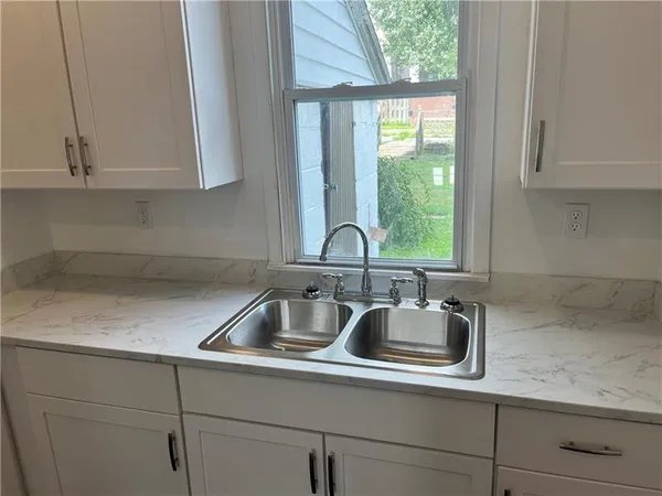 a kitchen with a sink and cabinets