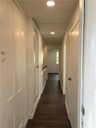 a view of a hallway with wooden floor