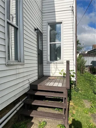 a view of a wooden bench sitting in back yard