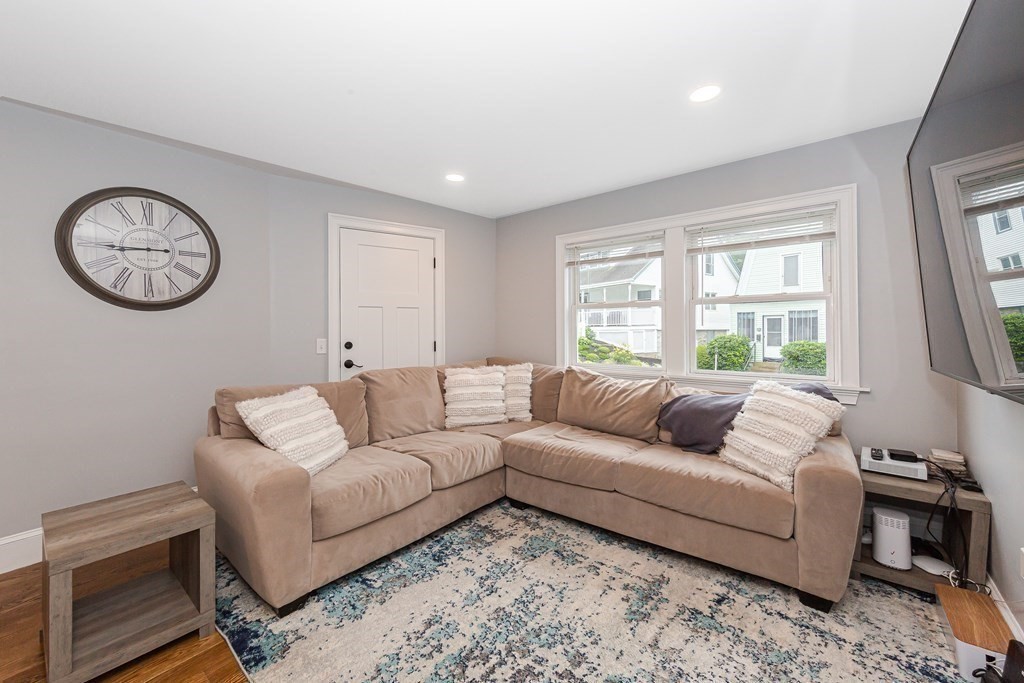 26 Foss Street, Unit 1 Medford, MA 02155 - Photo 12 of 35 a living room with furniture a window and a clock