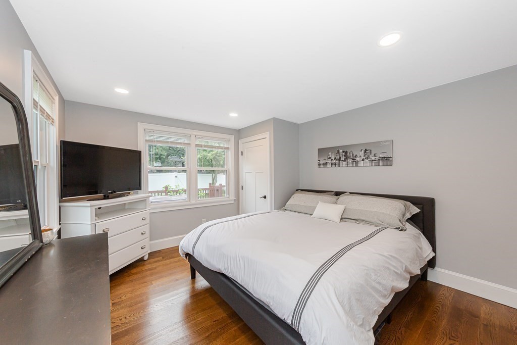 26 Foss Street, Unit 1 Medford, MA 02155 - Photo 17 of 35 a bedroom with a bed and a flat screen tv