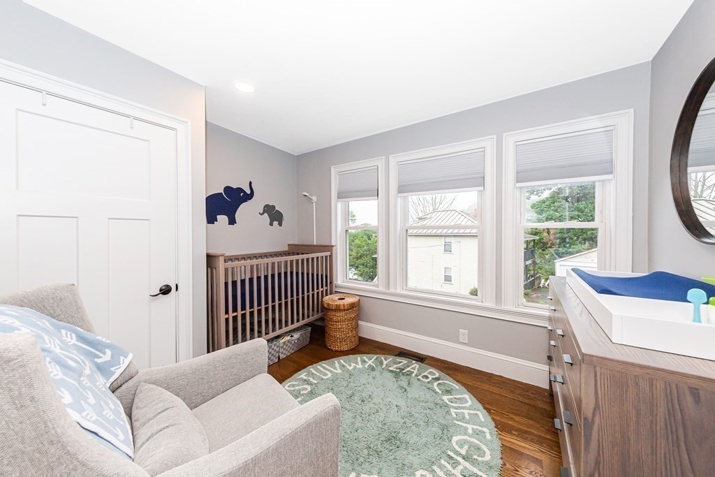 26 Foss Street, Unit 1 Medford, MA 02155 - Photo 20 of 35 a bed sitting in a bedroom next to a window